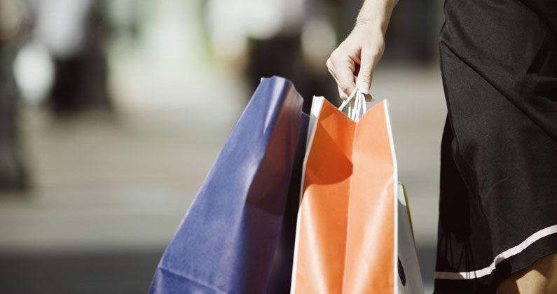 "woman carrying shopping bags''